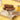 Drakes Cakes Mochaccino Devil Dogs on a white cake stand with a yellow background